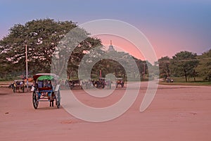 Horse carts on a dusty road in the temple area in Bagan Myanmar