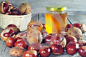 Horse chestnut and honey on a wooden table