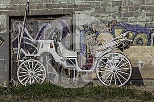 Horse drawn carriage against a wall