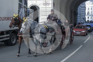Horse-drawn carriage carrying tourists along the old streets of Vienna, Austria, 12/27/2019