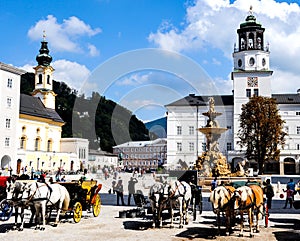 Horse drawn carriages in Residenzplatz Square in Salzburg, Austria.