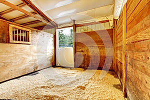 Horse farm empty stable interior.