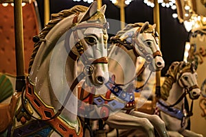 Horse figurines on a children& x27;s carousel in an amusement park