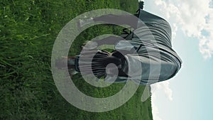 Horse with fly protection mask grazing on a meadow