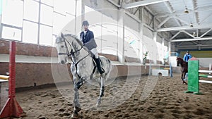 Horse girl rider jump over obstacle in slow motion