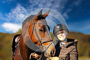 Horse head portraits in front of a blue sky and a rider standing next to it.