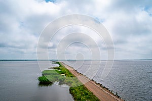 Horse Island Birdwatch Tower on the pier into the Liepaja lake in Liepaja, Latvia during sunny summer day photo