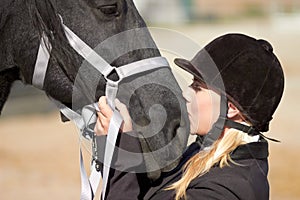 Horse kiss, trainer and woman on equestrian training and competition ground with a pet. Outdoor, female and show horses