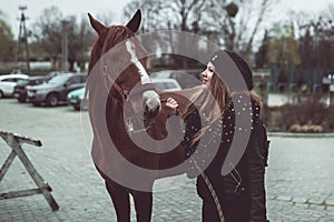 Horse looking into eyes of beautiful girl