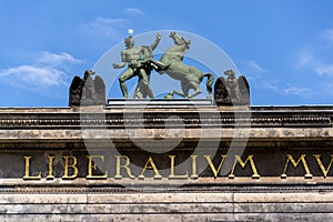 Horse with man bronze sculpture on the roof of Old Museum - Altes Museum in Berlin, Germany