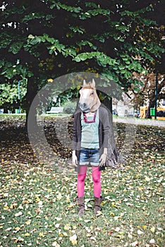 Horse mask woman in the park