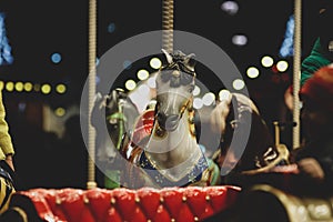 Horse on a merry-go-round carousel during a cold winter night