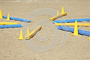 Horse obstacle course outdoors summertime. Poles in the sand at equestrian center outdoors