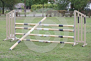 Horse obstacle course outdoors summertime. Poles in the sand at equestrian center outdoors