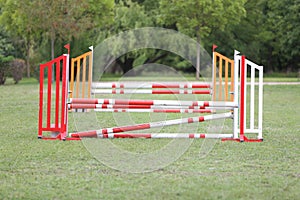 Horse obstacle course outdoors summertime. Poles in the sand at equestrian center outdoors