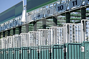 Horse race start gates with numbers on a sunny day