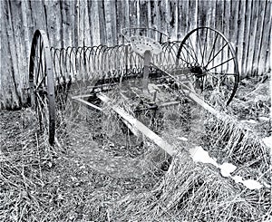 Horse rake for hay, vintage. Black and white photography. Poor land, no people, extinction.