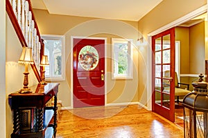 Horse ranch entryway with red door and hardwood floor. photo