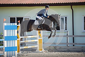 Horse and rider jumping on showjumping competition photo