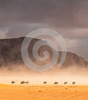 Horse riders traversing the Wadi-Rum desert photo