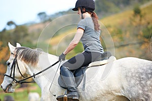 Horse riding, back or woman in countryside outdoor with rider or jockey for recreation or wellness. Sports, ready or