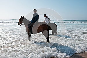 Horse riding at the beach at the ocean