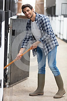 horse riding center groom cleaning stales