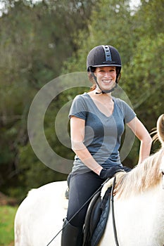 Horse riding, nature or portrait of happy woman in countryside outdoor with jockey for recreation. Sports, smile or