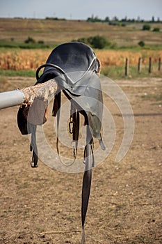Horse saddle on rural fence