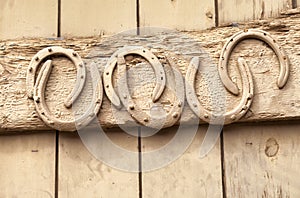 Horse shoes nailed to old wooden door photo