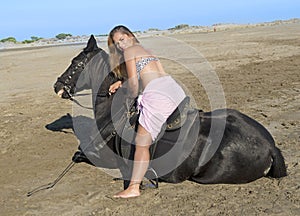 Horse woman on the beach