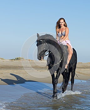 Horse woman on the beach