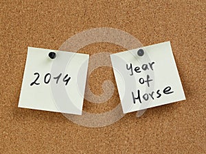 Horse year reminder note on cork board