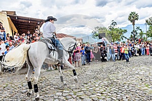 Horseback cowboy rides in village, Guatemala