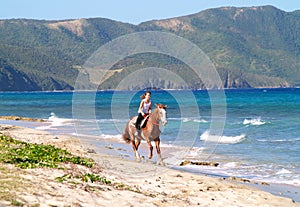 Horseback riding on beach.