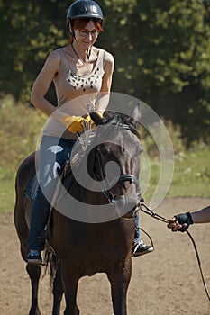 Horseback riding lessons - young woman riding a horse