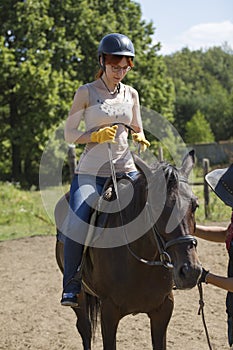 Horseback riding lessons - young woman riding a horse
