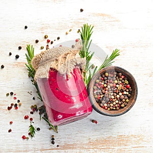 Horseradish and beetroot sauce in a glass jar.