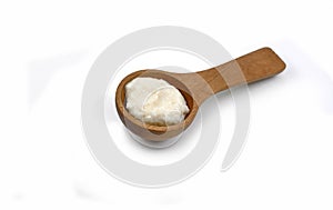 Horseradish sauce in wooden spoon isolated on white background