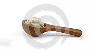 Horseradish sauce in wooden spoon isolated on white background