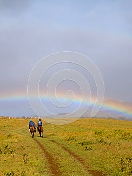 Horseriding under magic rainbow in Easter Island Rapa Nui Chile