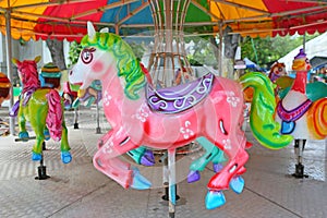 Horses on a carnival Merry Go Round in temple fair