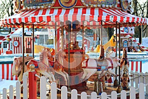 Horses carousel at the amusement entertainment park. Colorful carousel with horses, amusement park element. Children s
