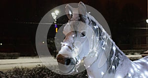 Horses with a carriage festoon. New Year`s street decoration
