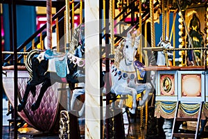 Horses of an old colorful and golden carousel - Merry go round
