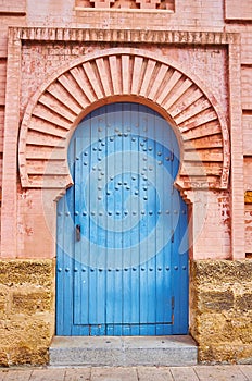 The horseshoe arch and vintage wooden door of Gran Teatro Falla theatre, Cadiz, Spain photo