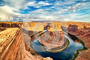 Horseshoe Bend on Colorado River at Beautiful Sunrise with Bright Blue Sky, Utah