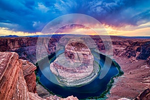 Horseshoe Bend on Colorado River at Sunset with Dramatic Cloudy Sky, Utah