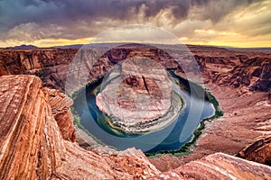 Horseshoe Bend on Colorado River at Sunset with Dramatic Cloudy Sky, Utah