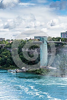 The Horseshoe Falls, part of Niagara Falls on the Canadian site of the Niagara River, partly hidden from green leaves